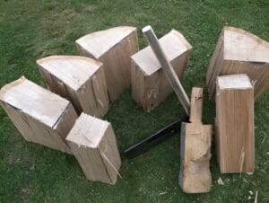 Wooden blocks and carving tools on grass.