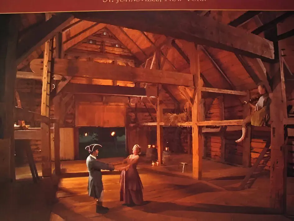 Couples dancing in a historic barn.