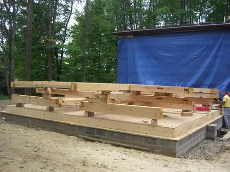 A wooden platform sitting in the middle of a forest.