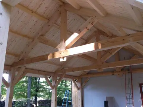 A wooden structure with beams and rafters in the center.